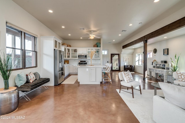 living room featuring concrete floors and ceiling fan