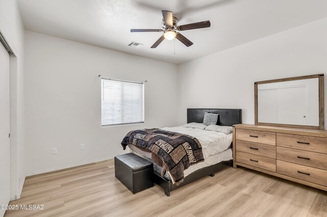 bedroom featuring a closet, ceiling fan, and light wood-type flooring