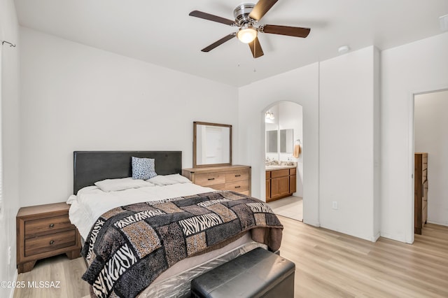 bedroom with ceiling fan, ensuite bath, sink, and light hardwood / wood-style floors