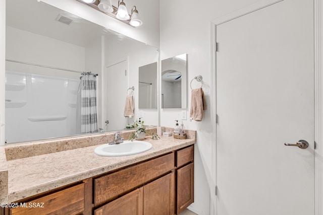 bathroom featuring vanity and curtained shower