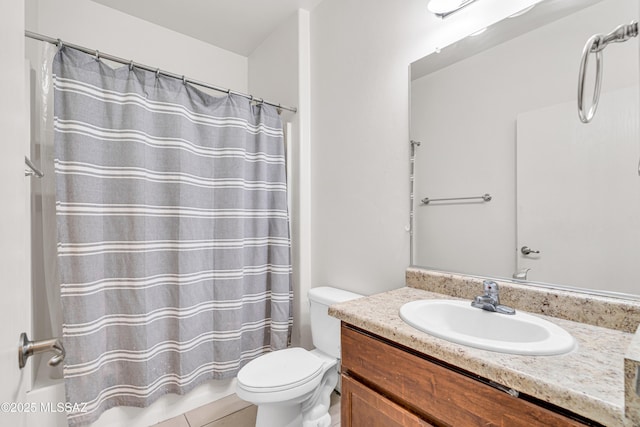 bathroom with a shower with curtain, vanity, toilet, and tile patterned flooring