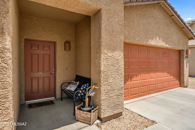 doorway to property with a garage