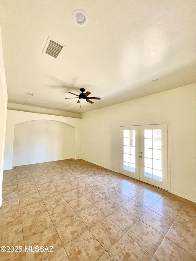 unfurnished room with light tile patterned floors, visible vents, a ceiling fan, and french doors