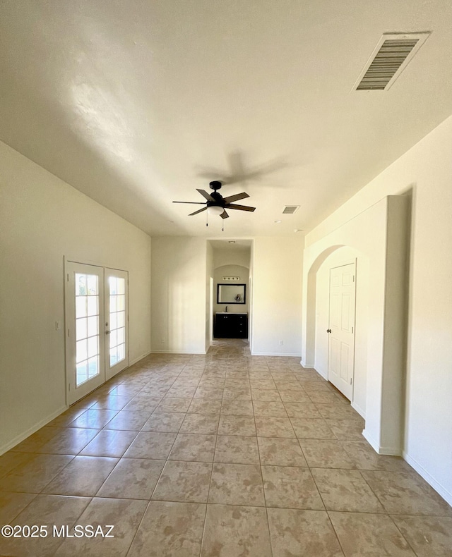 unfurnished living room featuring ceiling fan, french doors, light tile patterned floors, and visible vents