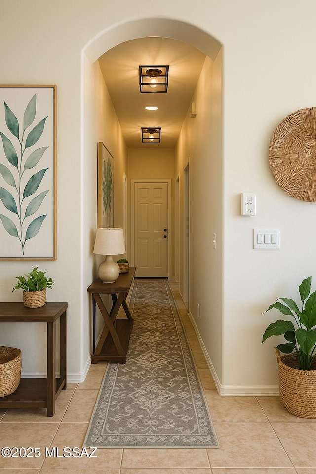 533 N Kino Springs Dr, Nogales, AZ 85621 - hallway featuring arched walkways, light tile patterned floors, and baseboards