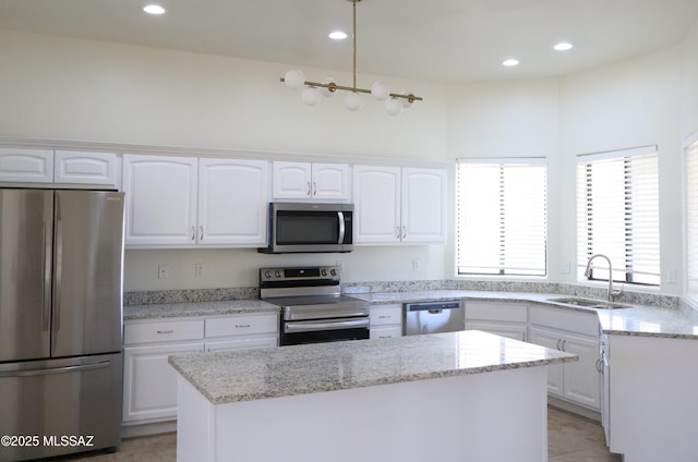 kitchen featuring appliances with stainless steel finishes, a sink, and white cabinetry