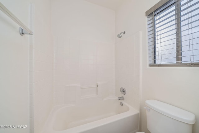bathroom featuring bathtub / shower combination and toilet