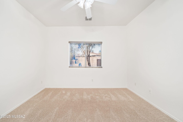 spare room featuring ceiling fan and light carpet
