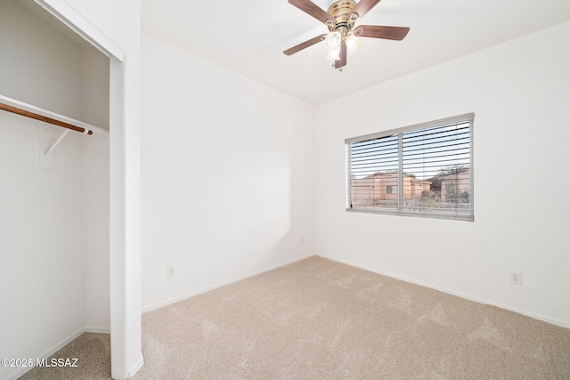 unfurnished bedroom featuring light colored carpet, a closet, and ceiling fan