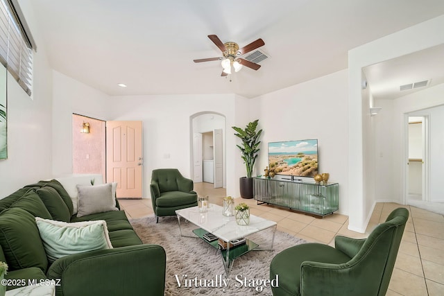 tiled living room with ceiling fan