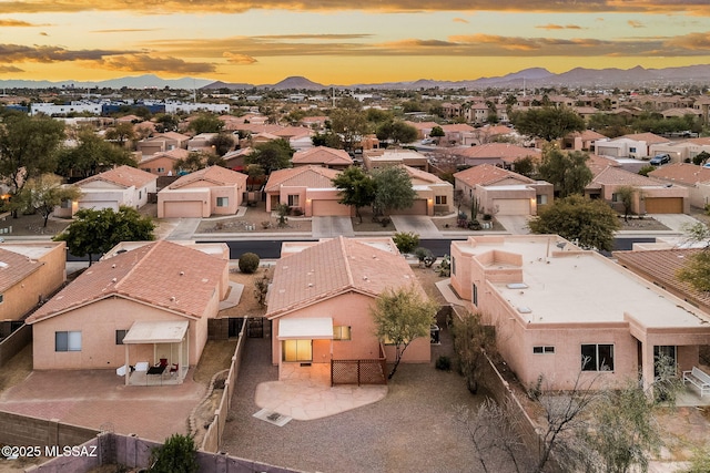 aerial view at dusk featuring a mountain view
