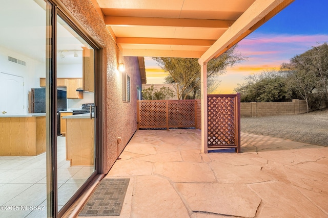 view of patio terrace at dusk