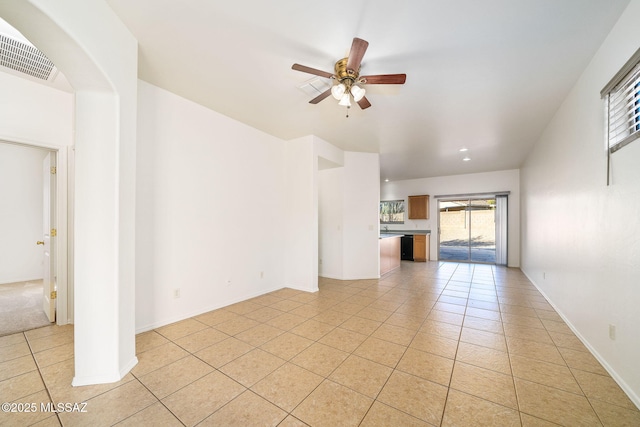 unfurnished living room featuring light tile patterned flooring and ceiling fan