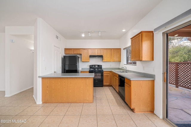 kitchen featuring light tile patterned floors, sink, and black appliances