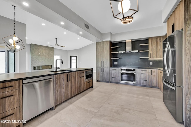 kitchen featuring sink, tasteful backsplash, pendant lighting, stainless steel appliances, and wall chimney range hood