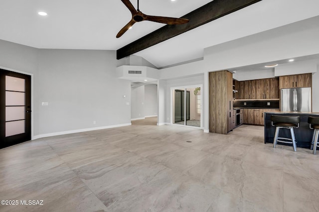 unfurnished living room featuring lofted ceiling with beams and ceiling fan