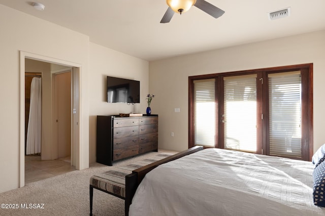 bedroom featuring access to exterior, light colored carpet, and ceiling fan