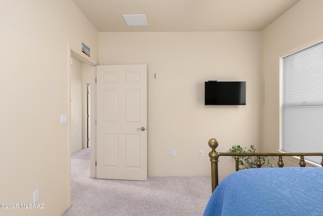 bedroom featuring light carpet