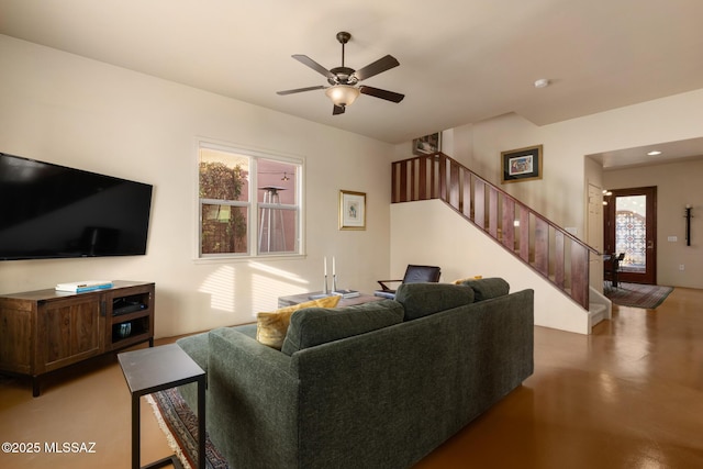 living room with concrete flooring and ceiling fan