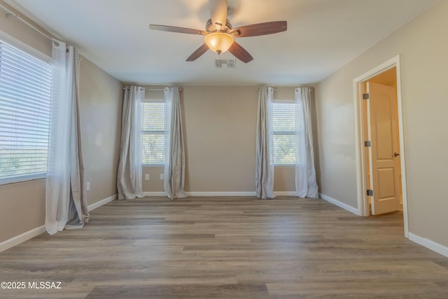 spare room with light hardwood / wood-style floors and ceiling fan