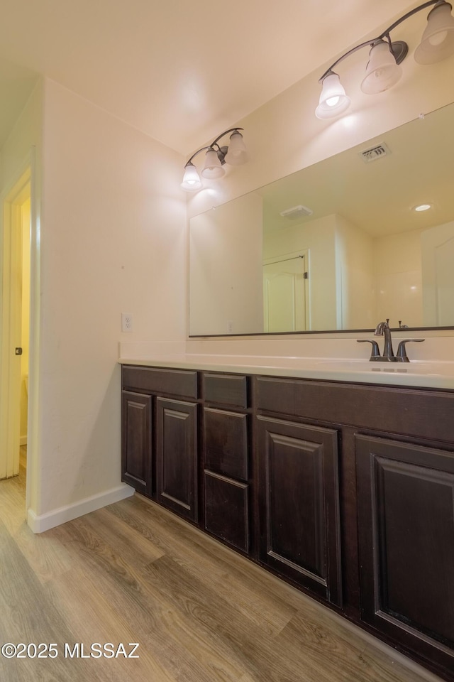 bathroom with vanity and hardwood / wood-style floors