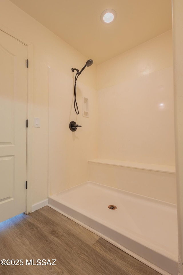 bathroom featuring walk in shower and hardwood / wood-style floors