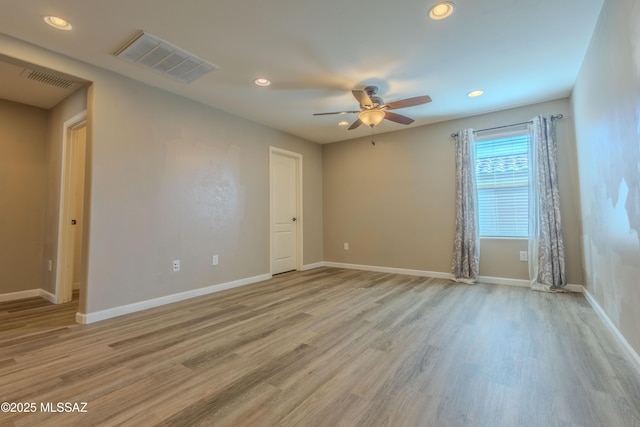 spare room with ceiling fan and light hardwood / wood-style floors