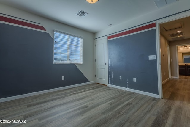 unfurnished bedroom with wood-type flooring and a closet