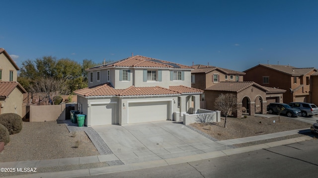 mediterranean / spanish home with a garage