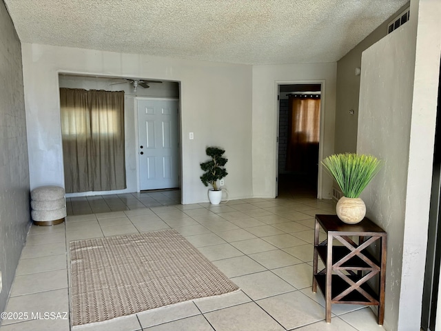 tiled foyer with a textured ceiling