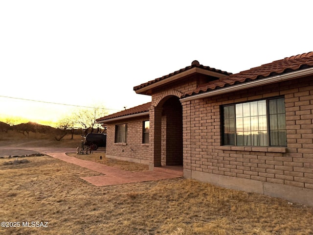 view of property exterior with a yard and a patio area