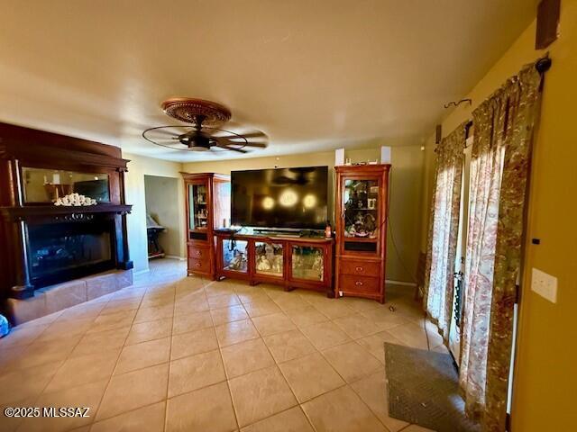 unfurnished living room featuring light tile patterned floors and ceiling fan