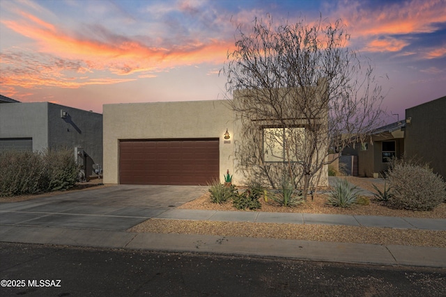 pueblo-style home with a garage