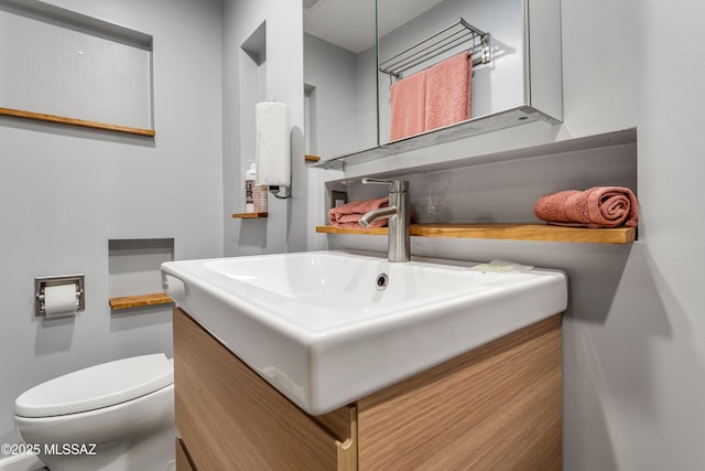 half bath featuring toilet and vanity