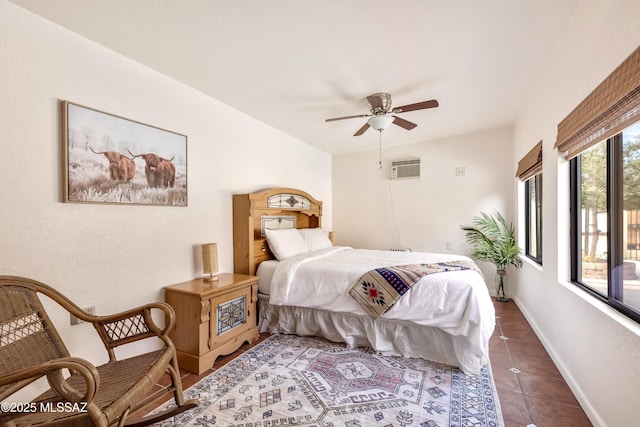 tiled bedroom featuring a ceiling fan and baseboards