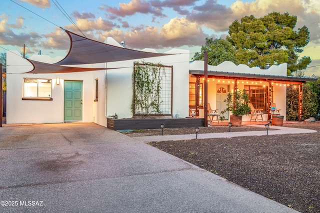 view of front of house with metal roof and stucco siding