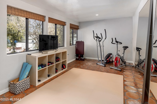 exercise room with recessed lighting and baseboards