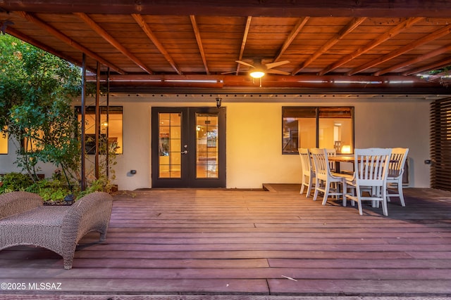 deck featuring outdoor dining space and french doors
