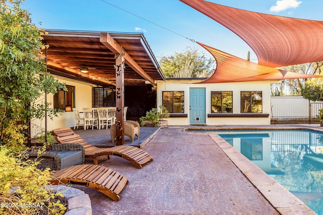 pool with ceiling fan and a patio area