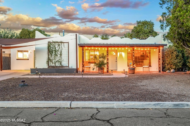 view of front of home with metal roof and stucco siding