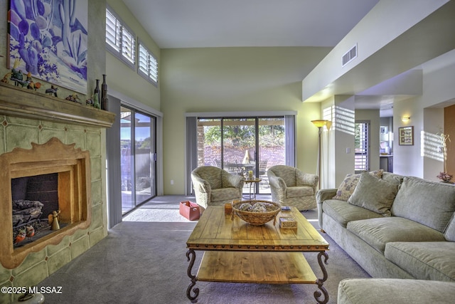 carpeted living room with a towering ceiling