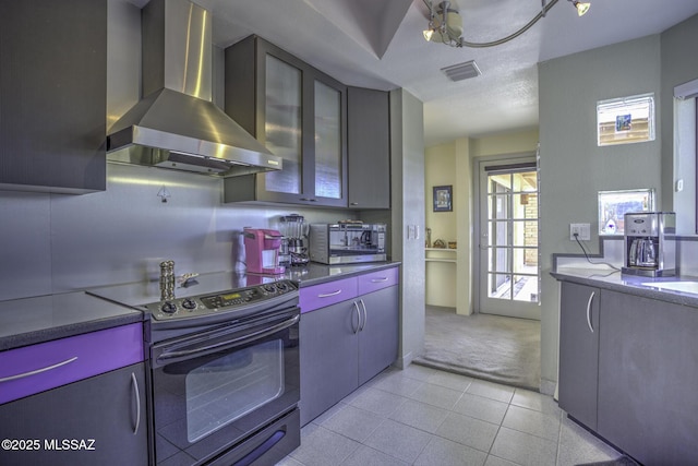 kitchen with ventilation hood, black electric range oven, and light tile patterned floors