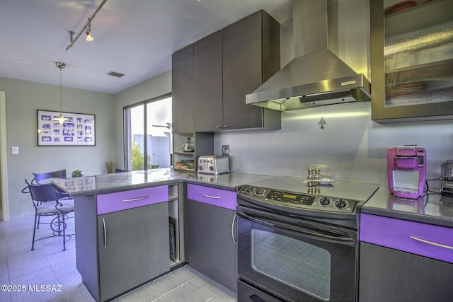 kitchen featuring rail lighting, hanging light fixtures, black range with electric cooktop, kitchen peninsula, and wall chimney exhaust hood