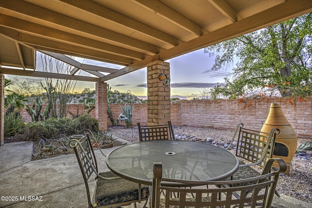 view of patio terrace at dusk