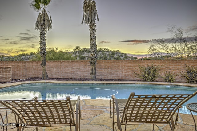 view of pool at dusk