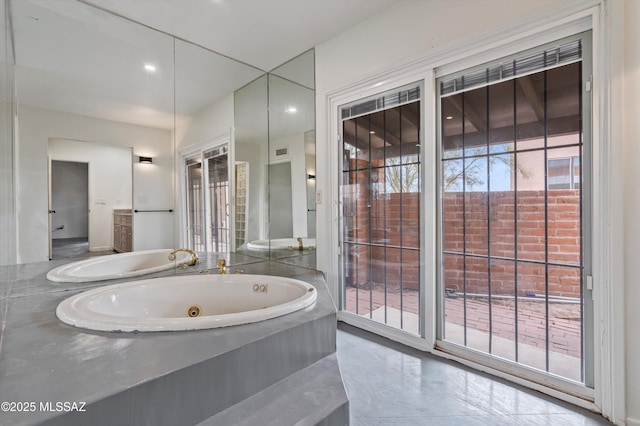 bathroom featuring a relaxing tiled tub