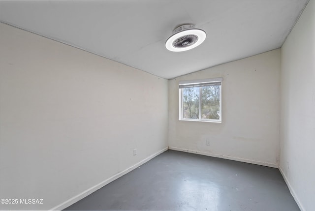 empty room featuring lofted ceiling