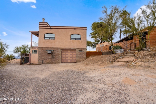 rear view of house featuring a garage