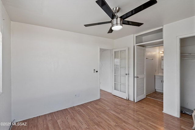 unfurnished bedroom with light hardwood / wood-style floors, a closet, and ceiling fan