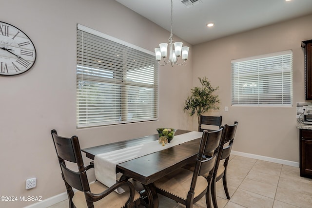 dining area featuring light tile patterned flooring and a chandelier